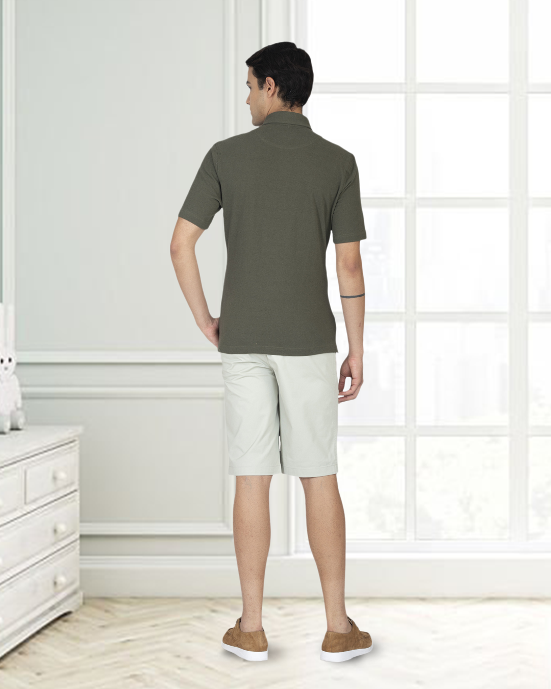 Back view of model wearing custom Genoa shorts for men by Luxire in pale green