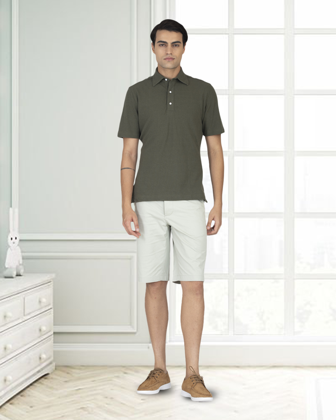 Model wearing custom Genoa shorts for men by Luxire in pale green hands at side