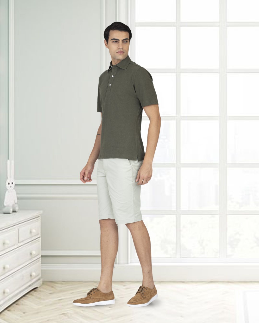 Model wearing custom Genoa shorts for men by Luxire in pale green white background