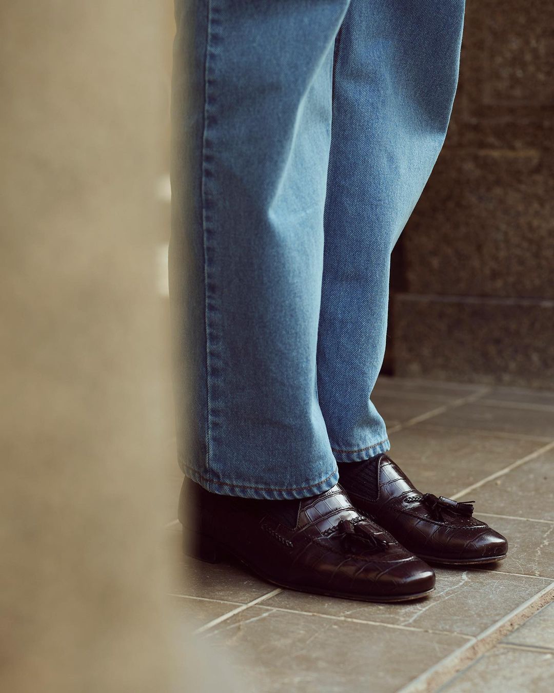 Close up of model wearing mens fade washed jeans by Luxire in indigo 3