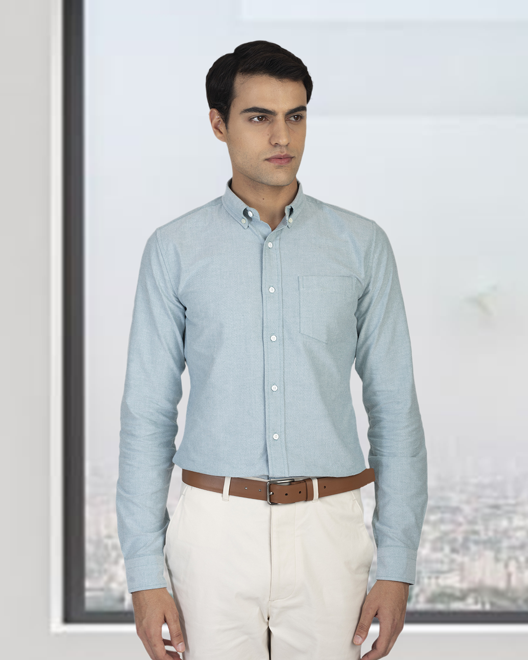 Front close up of model wearing the custom oxford shirt for men by Luxire in mint green