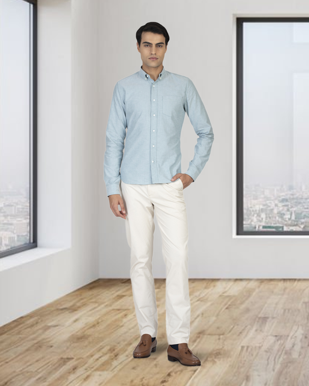 Front of model wearing the custom oxford shirt for men by Luxire in mint green hand at side