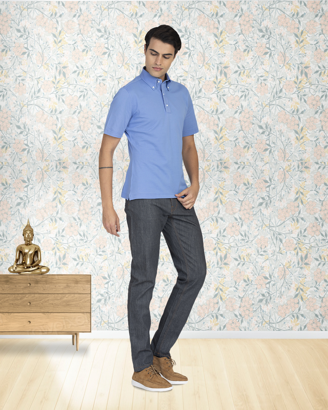 Front of model wearing the custom oxford polo shirt for men by Luxire in soft blue with grey background
