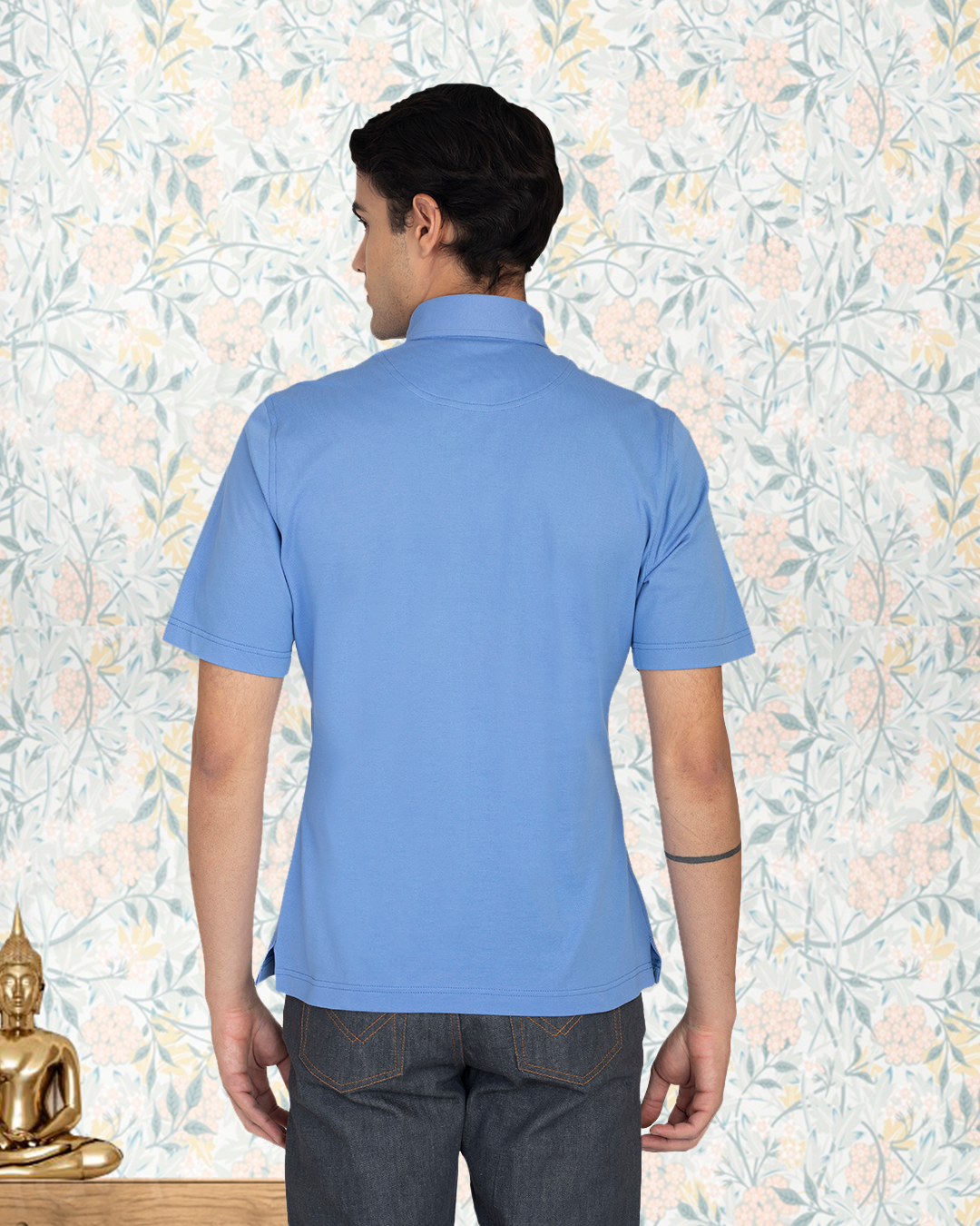 Back of model wearing the custom oxford polo shirt for men by Luxire in soft blue