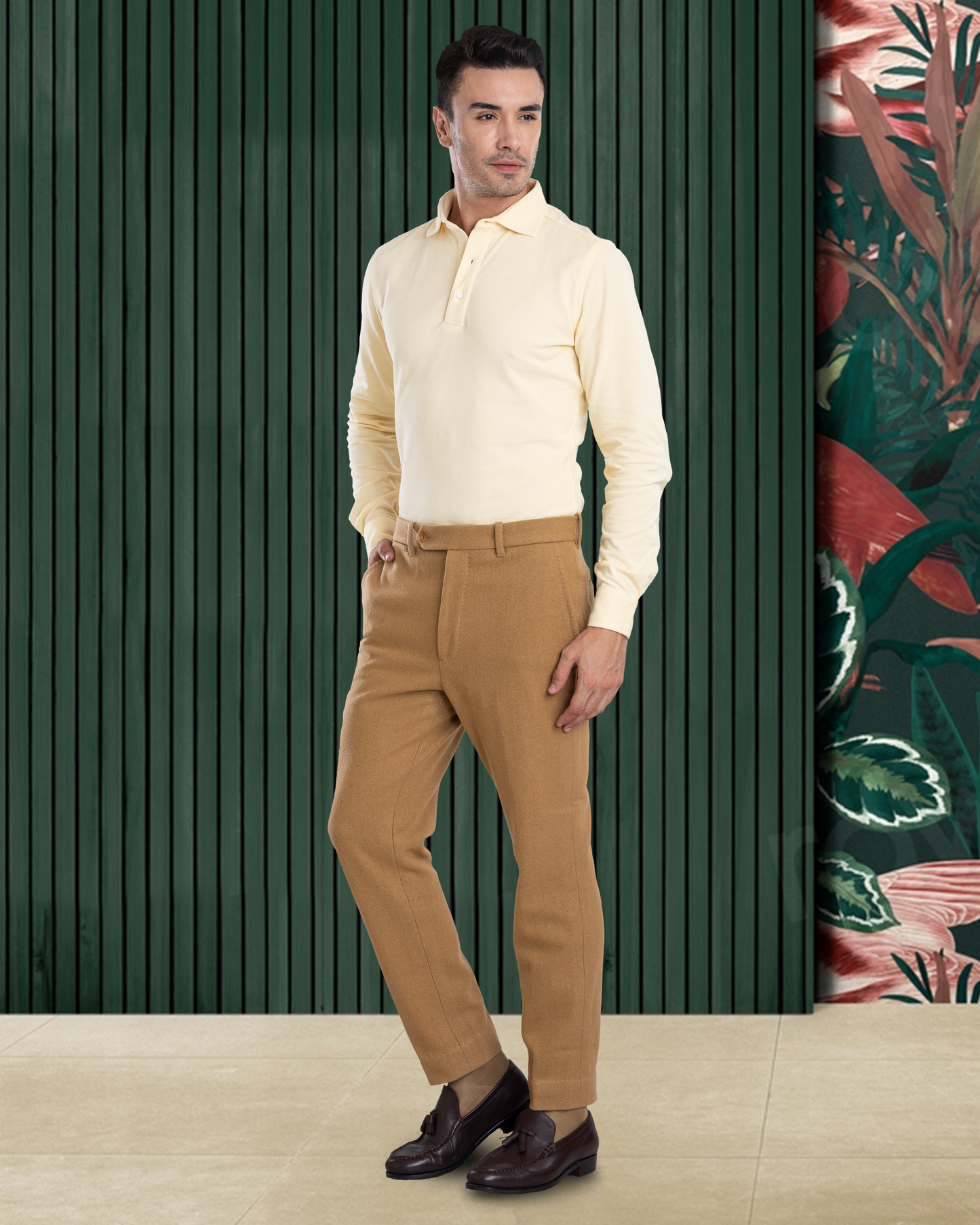 Model wearing the custom oxford polo shirt for men by Luxire in butter yellow one hand in pocket