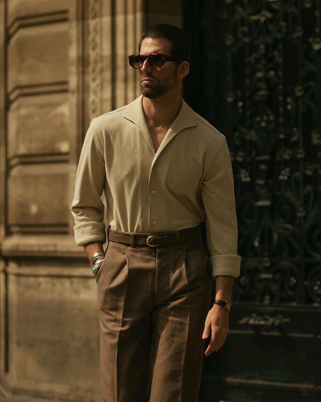 Model wearing the custom oxford polo shirt for men by Luxire in heather cream one hand in pocket