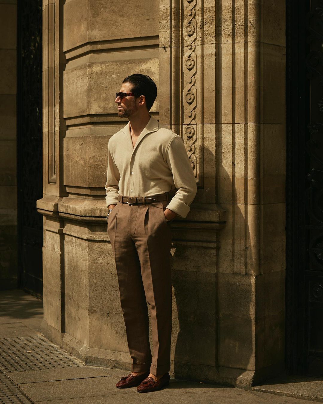 Model wearing the custom oxford polo shirt for men by Luxire in heather cream hands in pockets 4