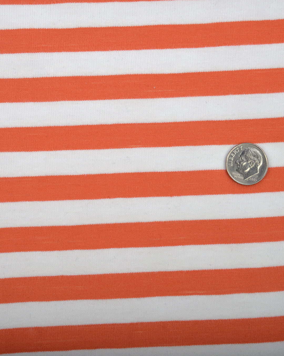 Close up of the custom oxford polo shirt for men by Luxire in orange and white stripes
