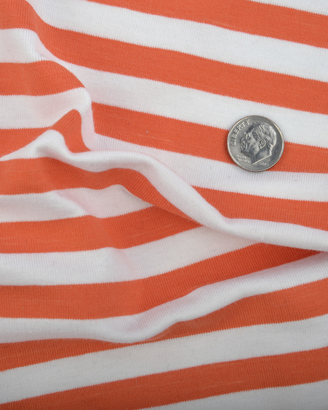 Close up of the custom oxford polo shirt for men by Luxire in orange and white stripes 2