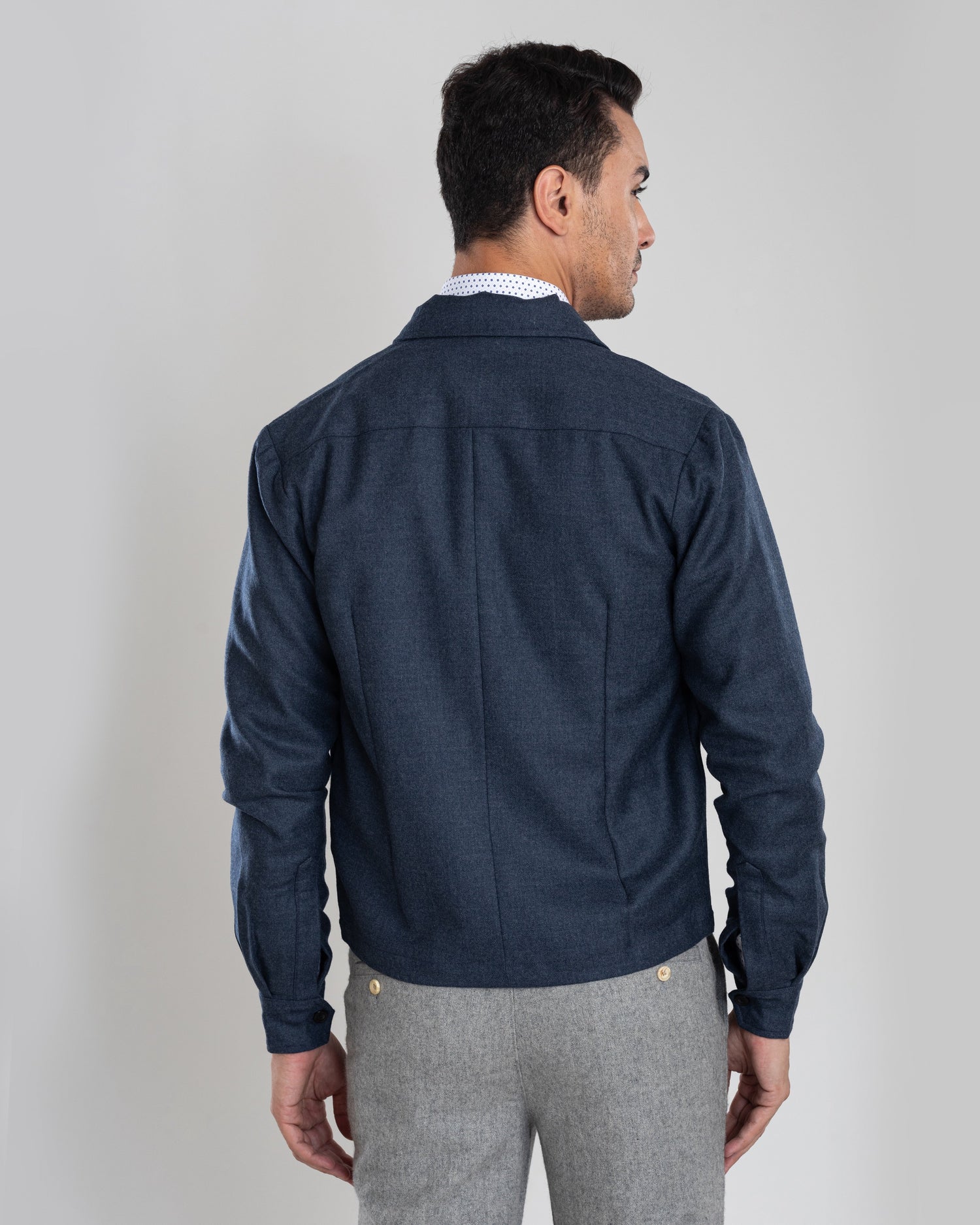 Back of model wearing the wool flannel shirt jacket for men by Luxire in dugdale navy