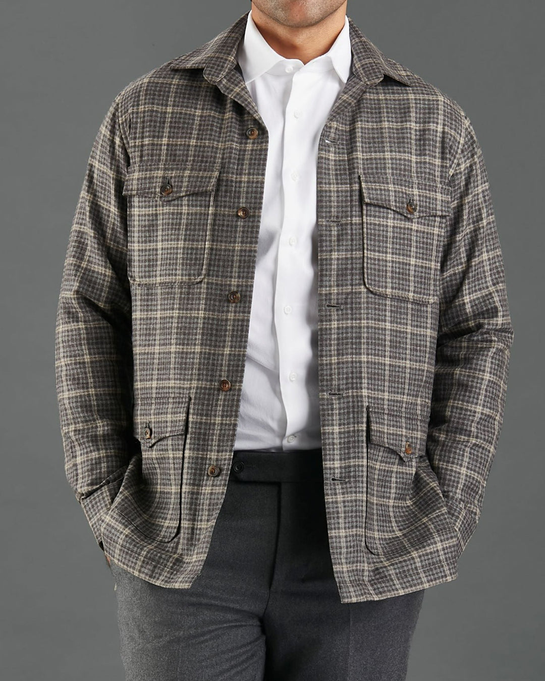 Front of model wearing the shirt jacket for men by Luxire in brown and grey overchecks