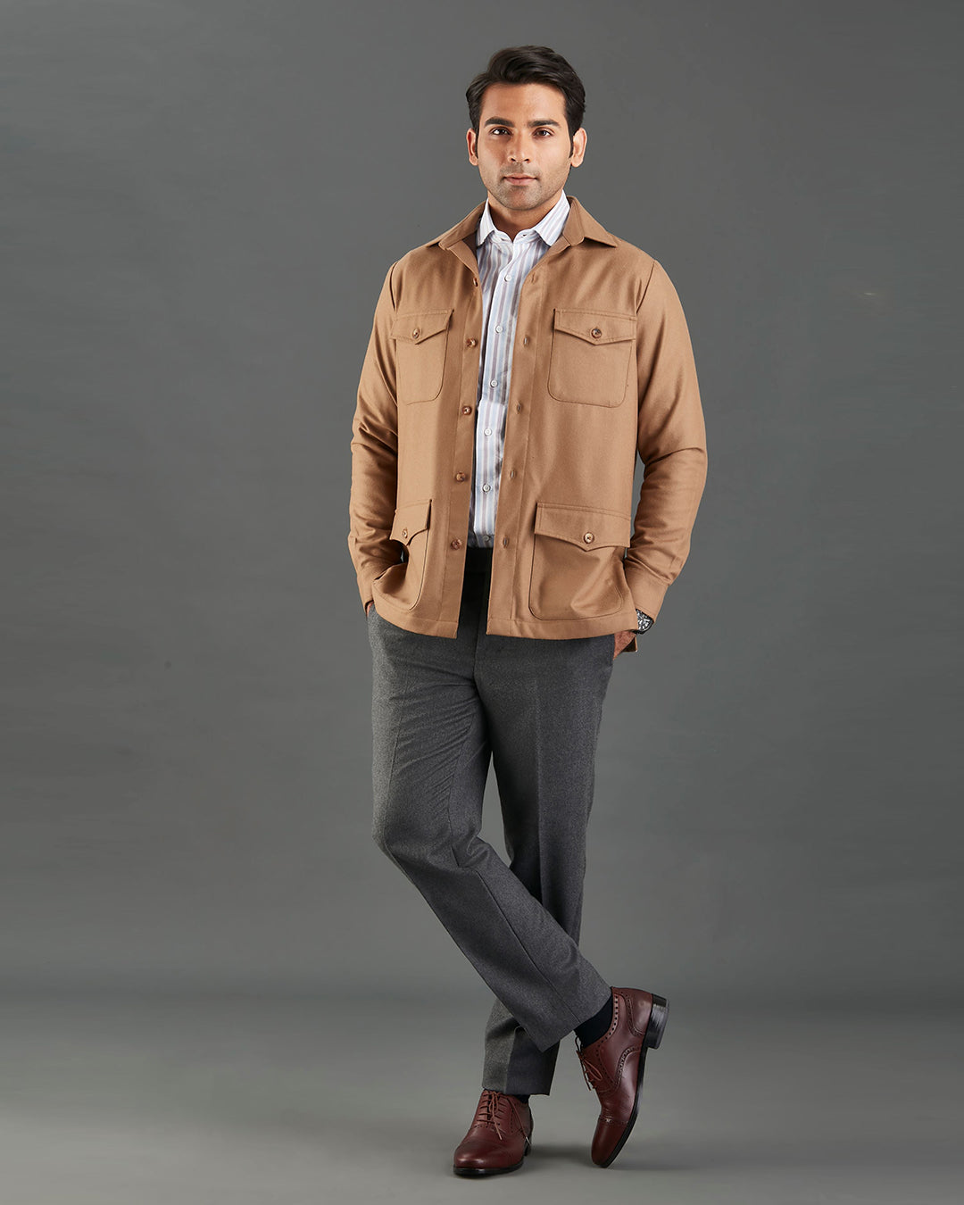 Front of model wearing the woolen flannel shirt jacket for men by Luxire in tan hands in pockets