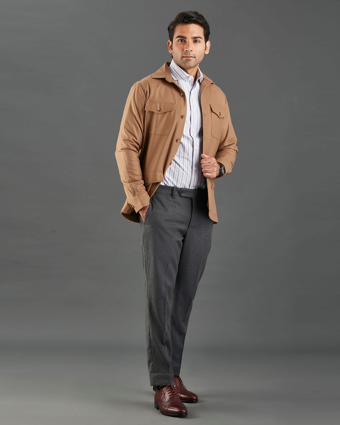 Side of model wearing the woolen flannel shirt jacket for men by Luxire in tan hands in pockets