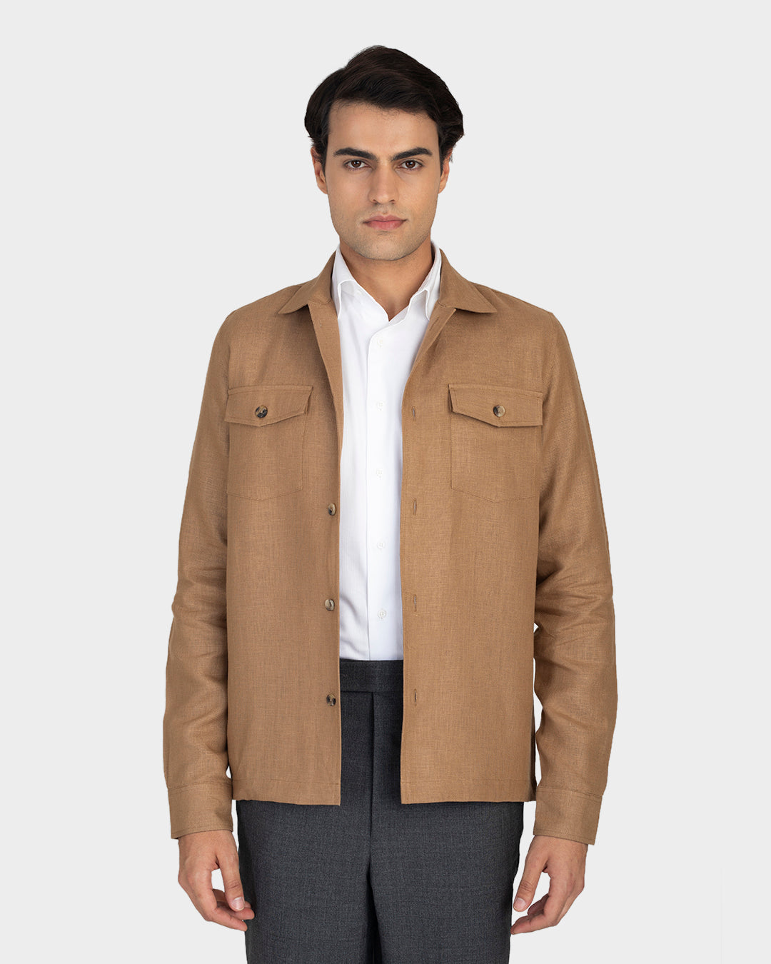Front of model wearing the linen shirt jacket for men by Luxire in golden brown hands at side