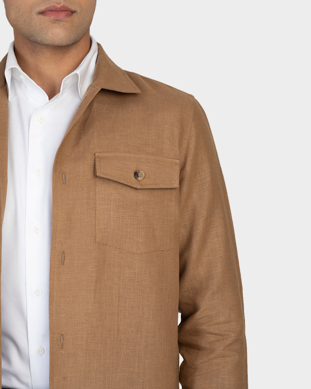 Close up of model wearing the linen shirt jacket for men by Luxire in golden brown