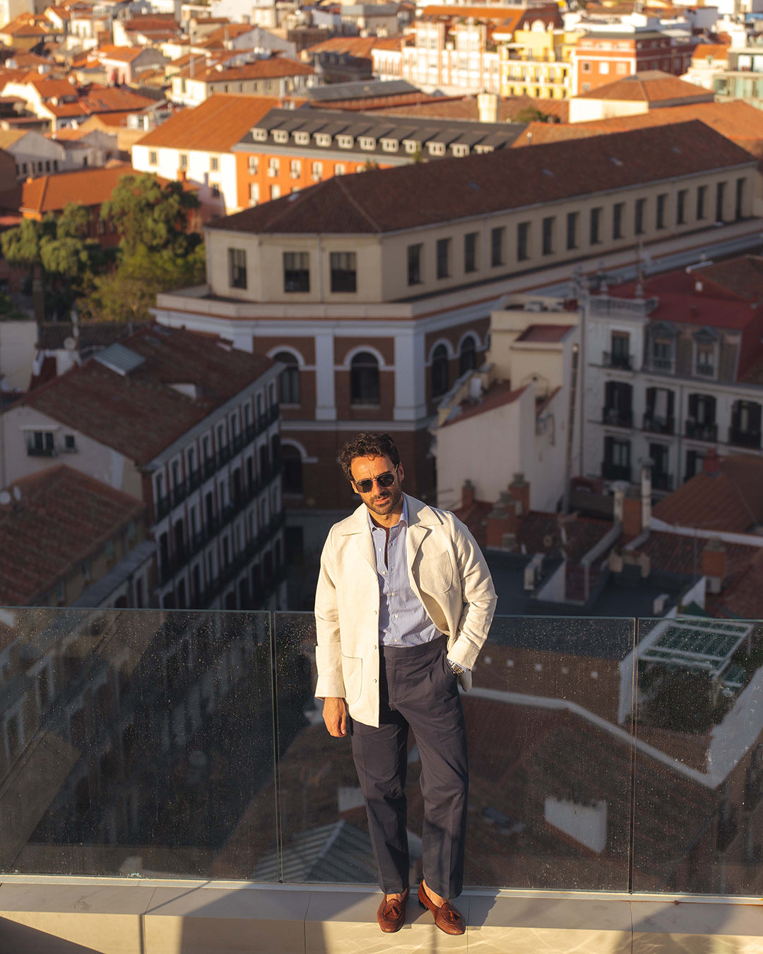 Model outside wearing the linen shirt jacket for men by Luxire in cream wearing sunglasses 8