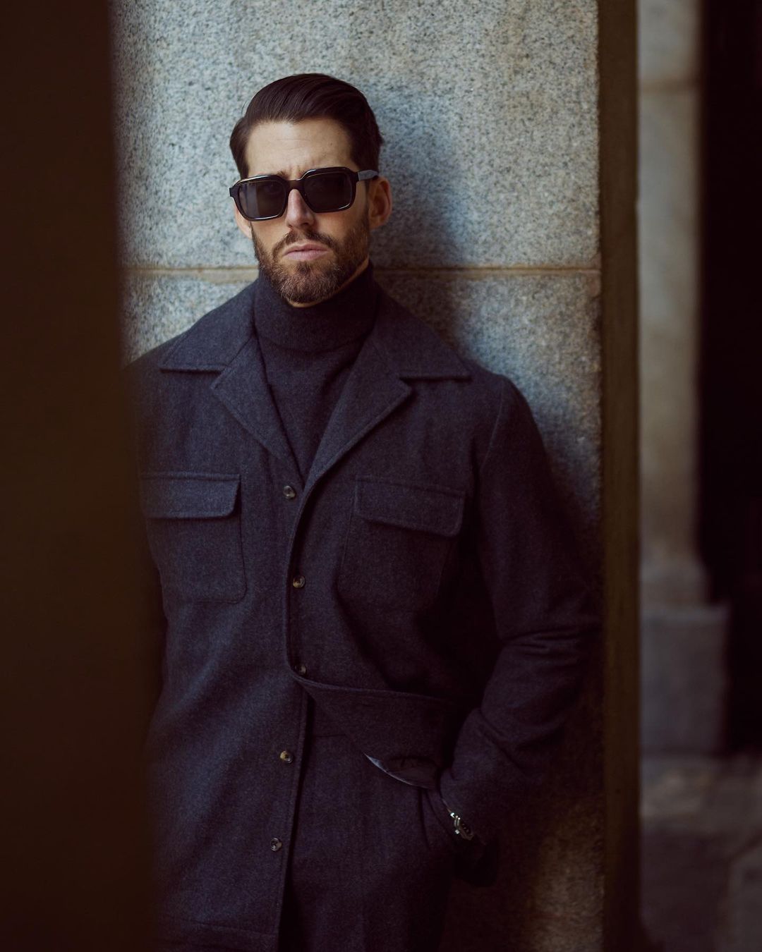 Model wearing the recycled wool shirt jacket for men by Luxire in charcoal grey wearing sunglasses