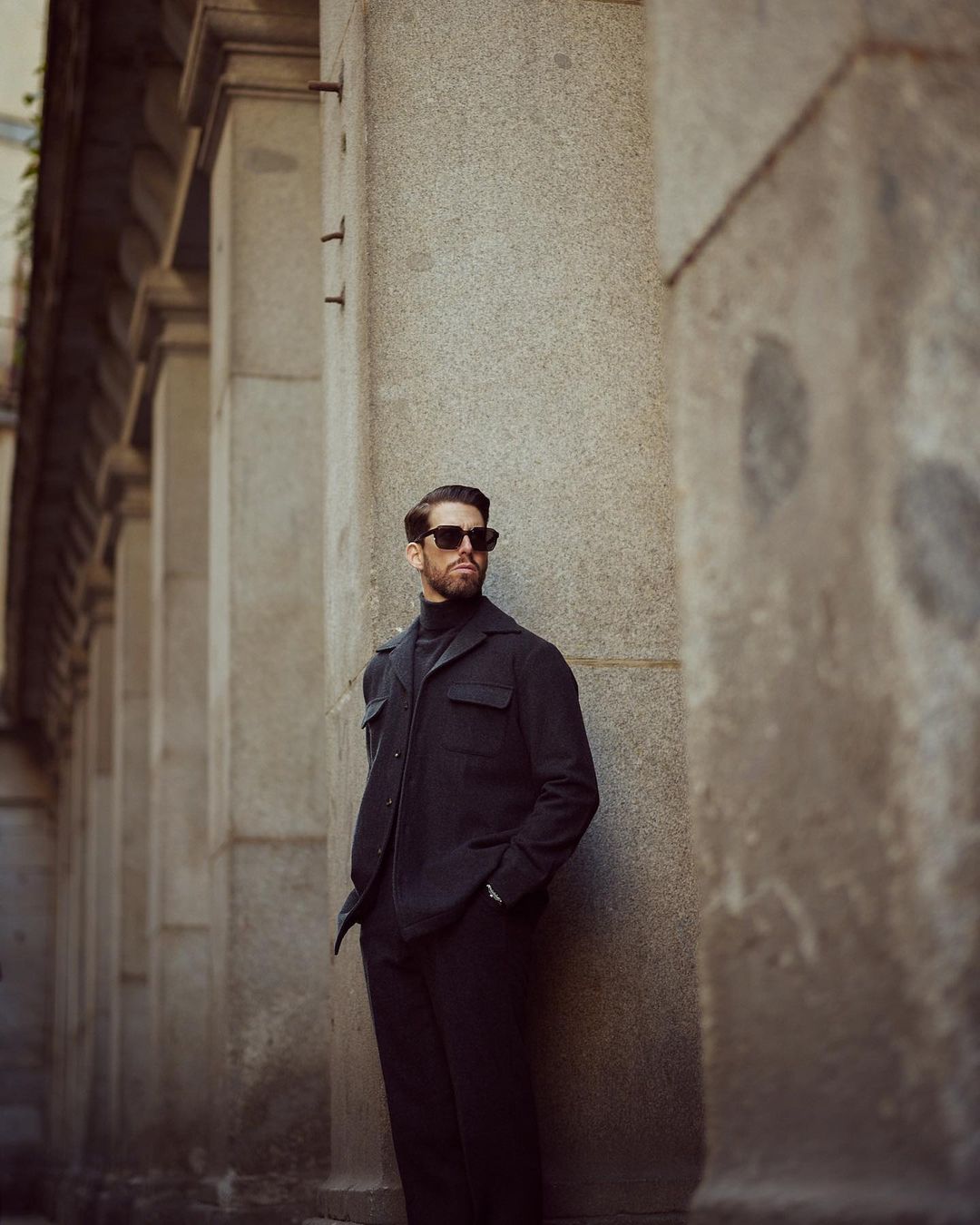 Model wearing the recycled wool shirt jacket for men by Luxire in charcoal grey wearing sunglasses 3