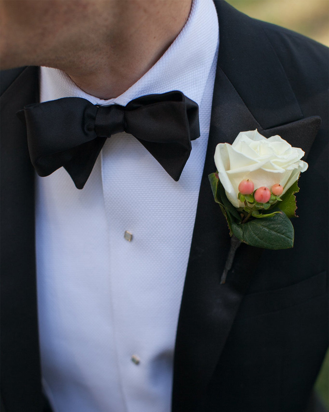 Model wearing the mens tuxedo shirt by Luxire called classic with black bow tie and black jacket