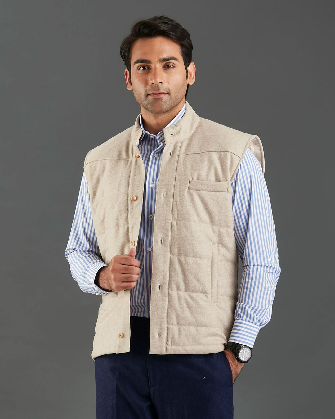 Front of model wearing the flannel quilted vest for men by Luxire in ecru hands in pockets 2