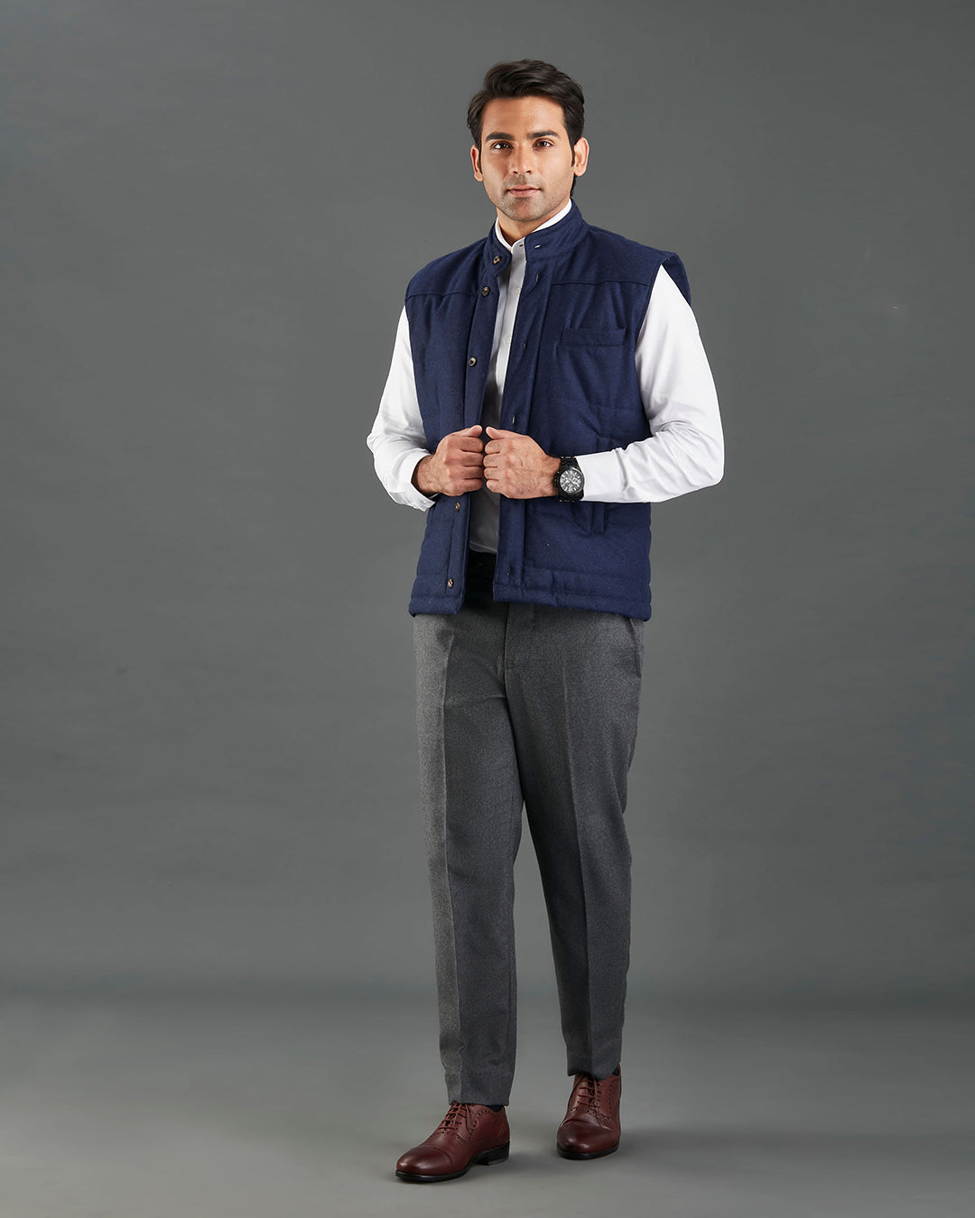 Model wearing the flannel quilted vest for men by Luxire in navy hands together