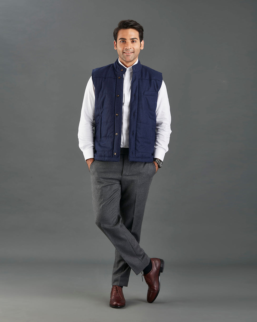 Model wearing the flannel quilted vest for men by Luxire in navy hands in pockets