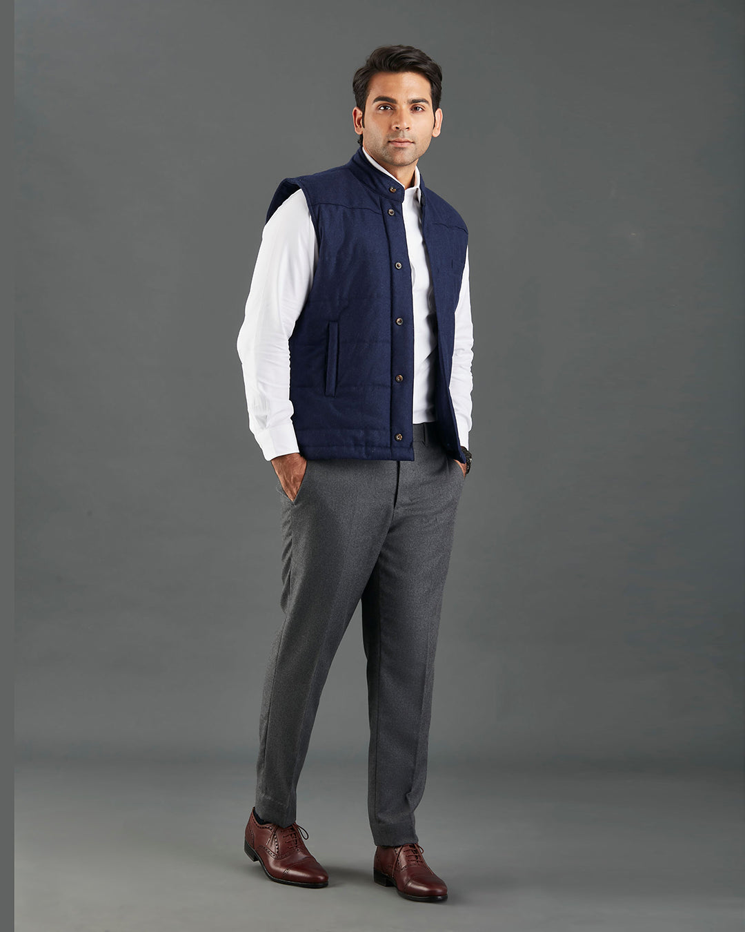Model wearing the flannel quilted vest for men by Luxire in navy hands in pockets 2