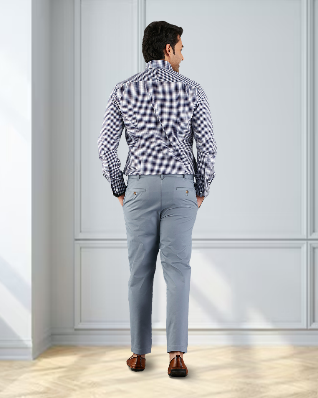 Back view of model wearing custom Genoa Chino pants for men by Luxire in soft blue grey
