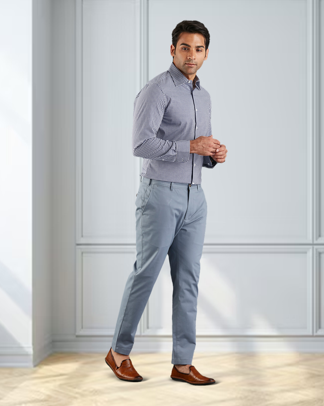 Model  wearing custom Genoa Chino pants for men by Luxire in soft blue grey hands together