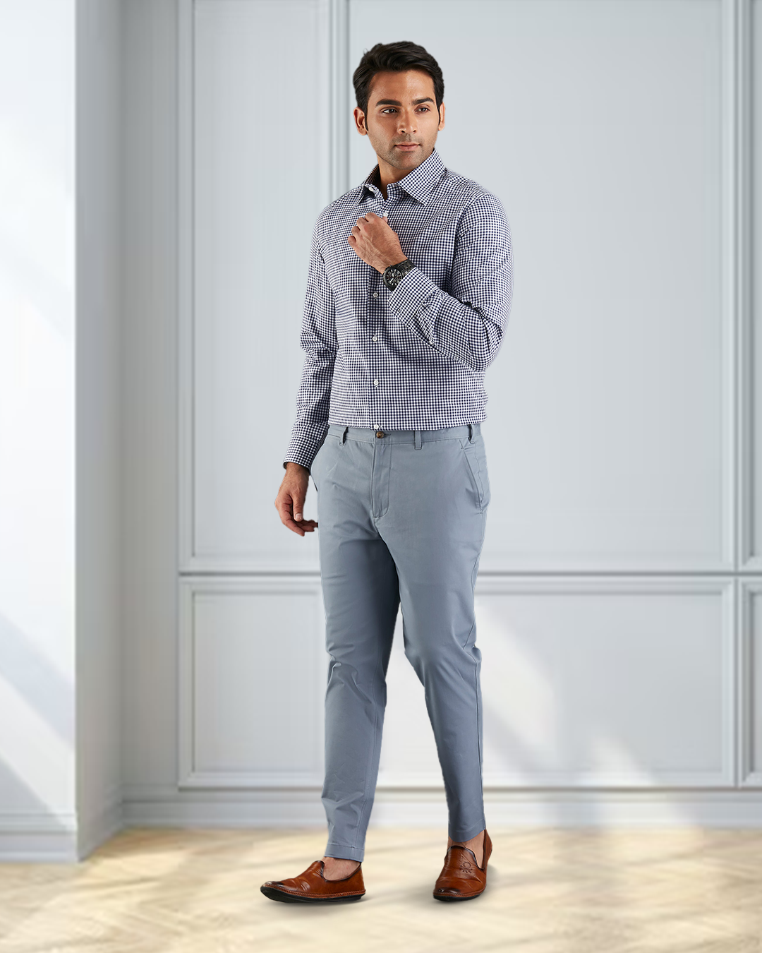 Front view of model  wearing custom Genoa Chino pants for men by Luxire in soft blue grey hand at chest