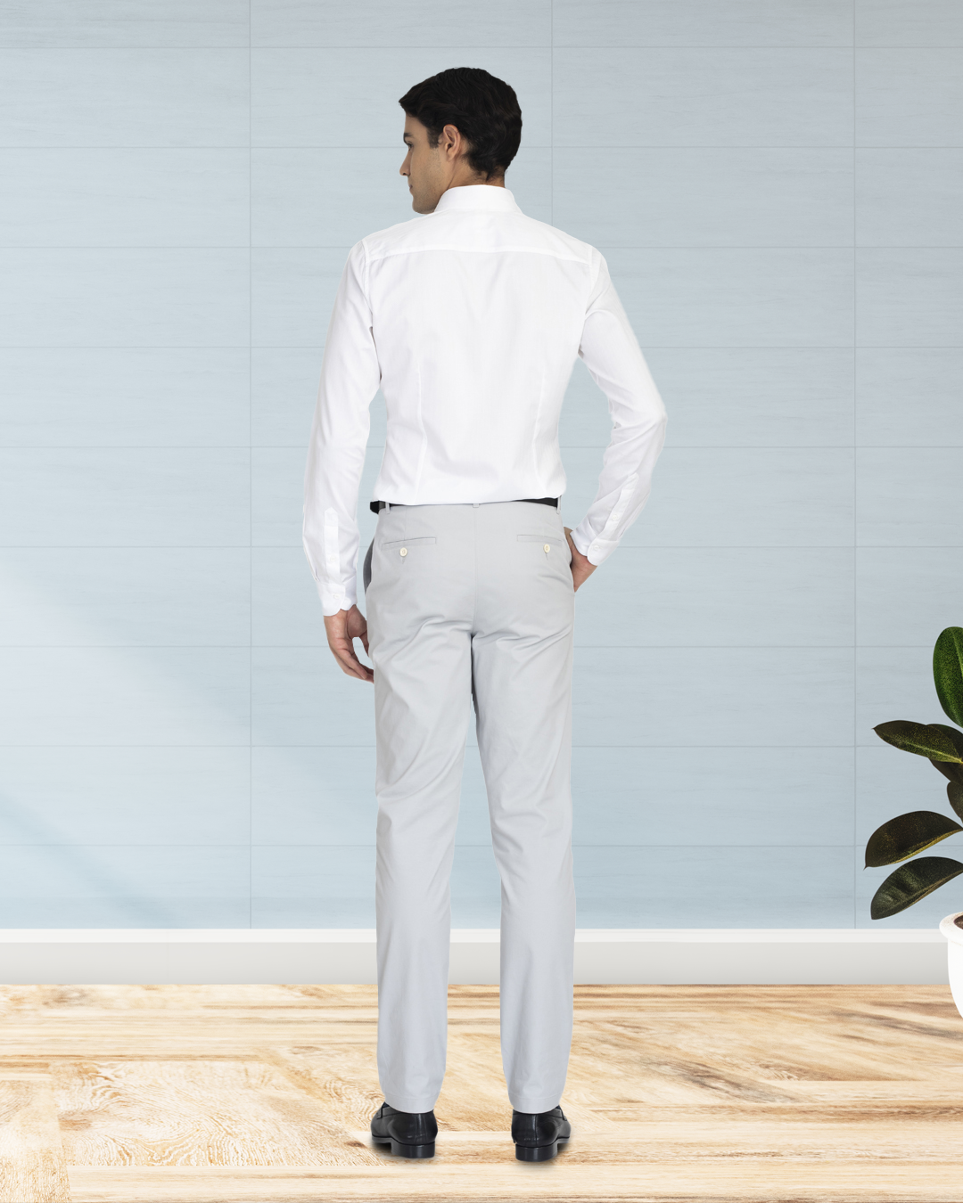 Back view of model wearing custom Genoa Chino pants for men by Luxire in light grey hand in pocket