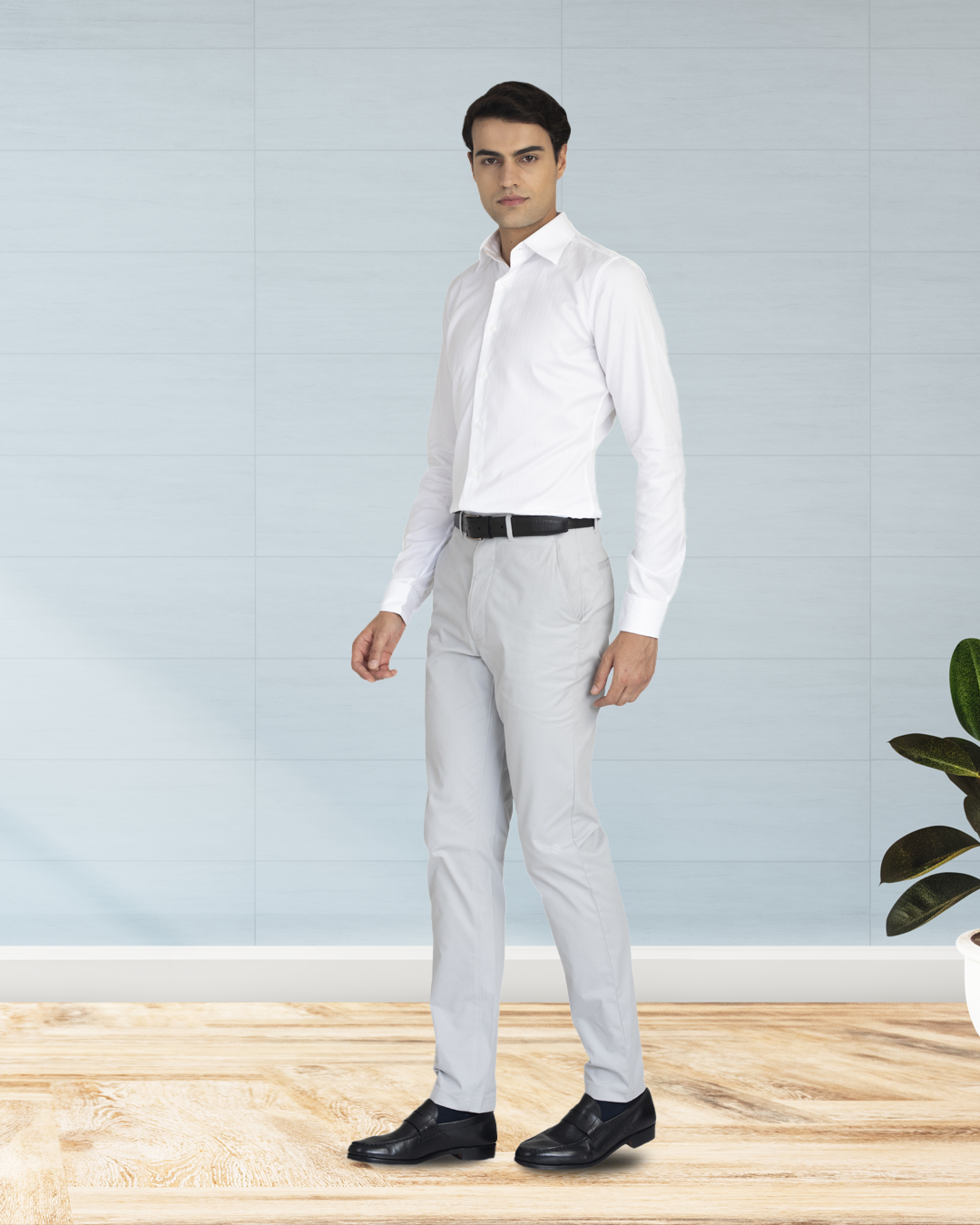Model wearing custom Genoa Chino pants for men by Luxire in light grey hands at side