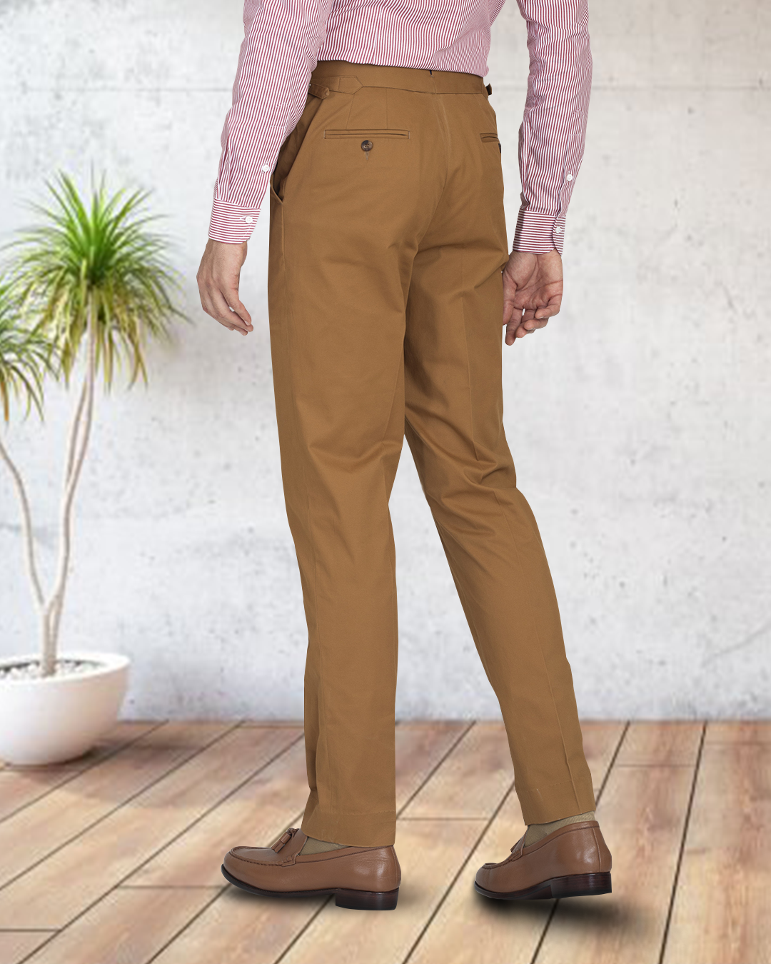 Back view of model wearing custom Genoa Chino pants for men by Luxire in copper wearing brown shoes