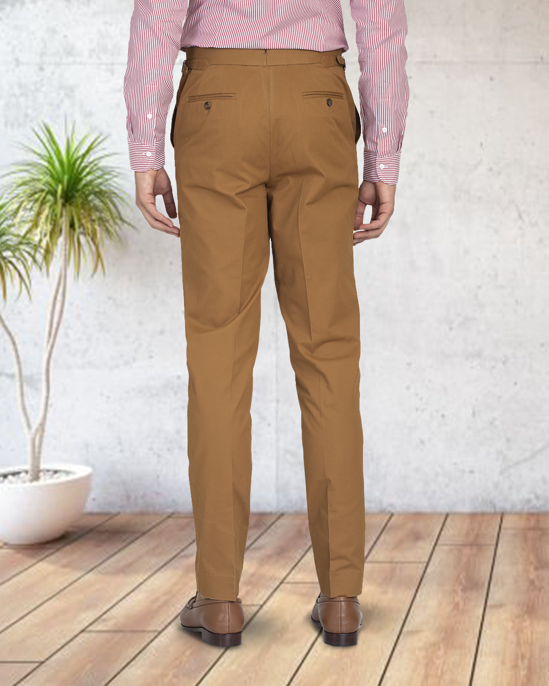 Back view of model wearing custom Genoa Chino pants for men by Luxire in copper