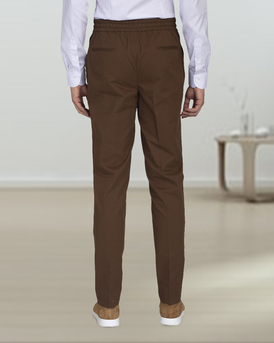 Front close-up view of model wearing custom Genoa drawstring pants for men by Luxire in coffee brown