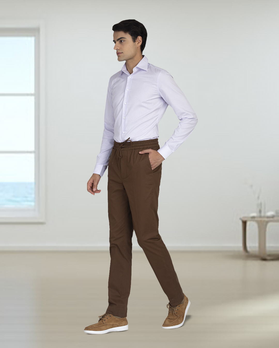 Side view of model wearing custom Genoa drawstring pants for men by Luxire in coffee brown