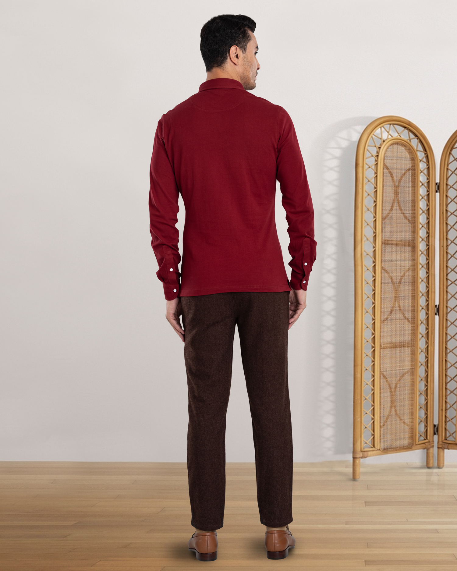 Back view of model wearing custom wool Chino pants for men by Luxire in brown