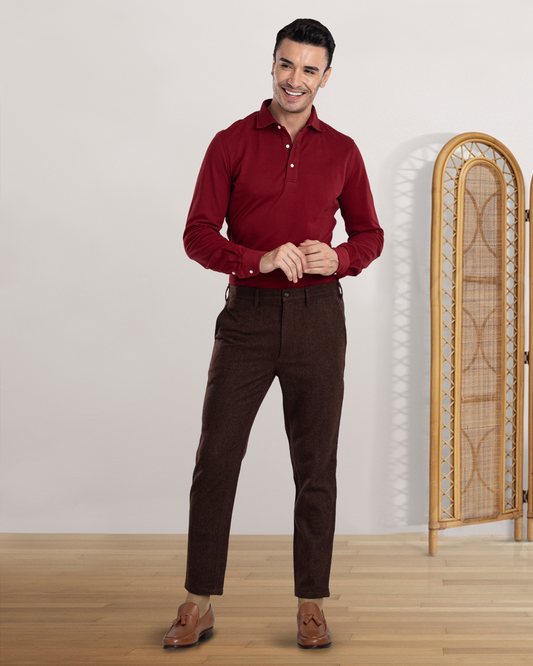Model wearing custom wool Chino pants for men by Luxire in brown hands together