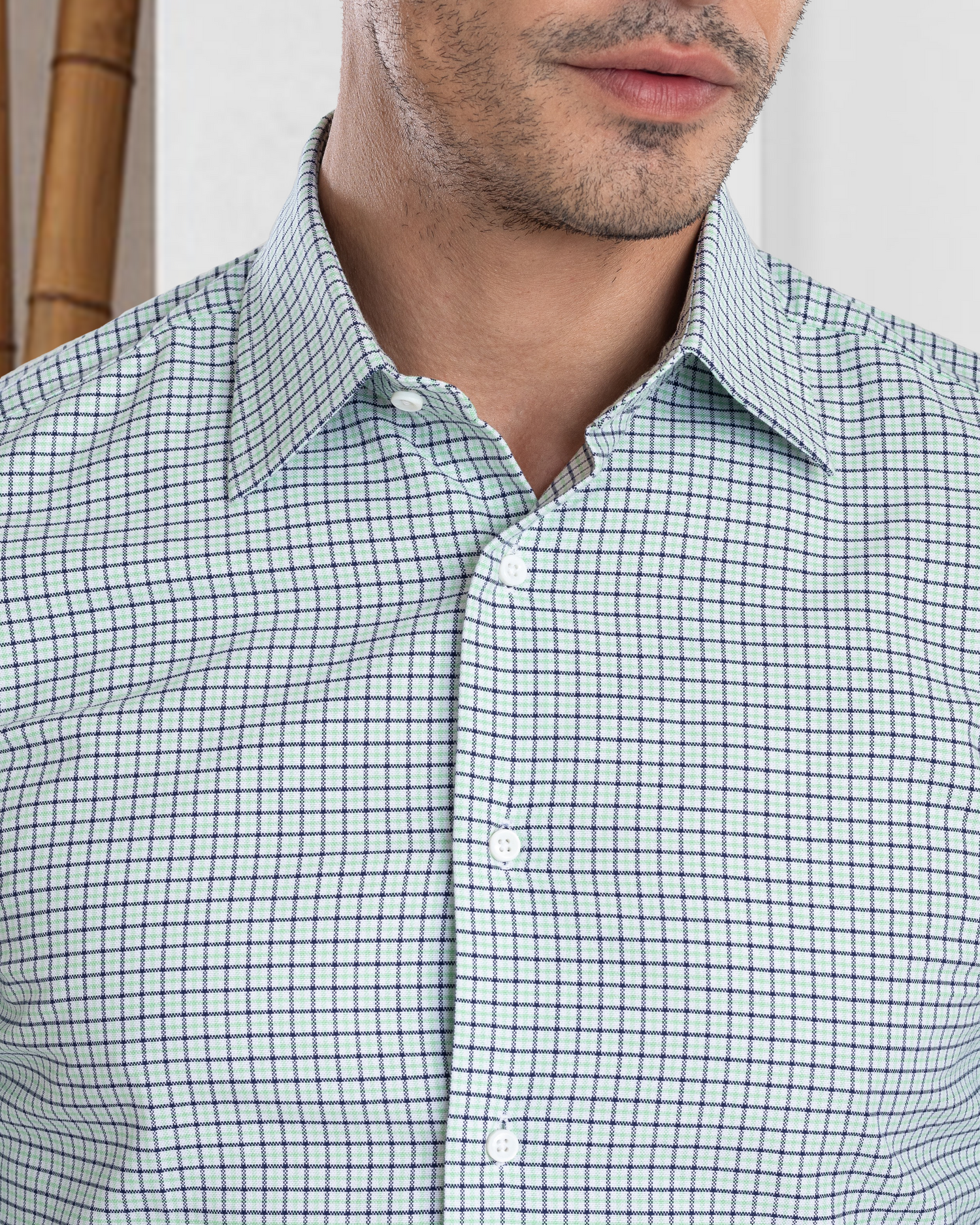 Model close up wearing custom check shirts for men by Luxire in green blue tattersall