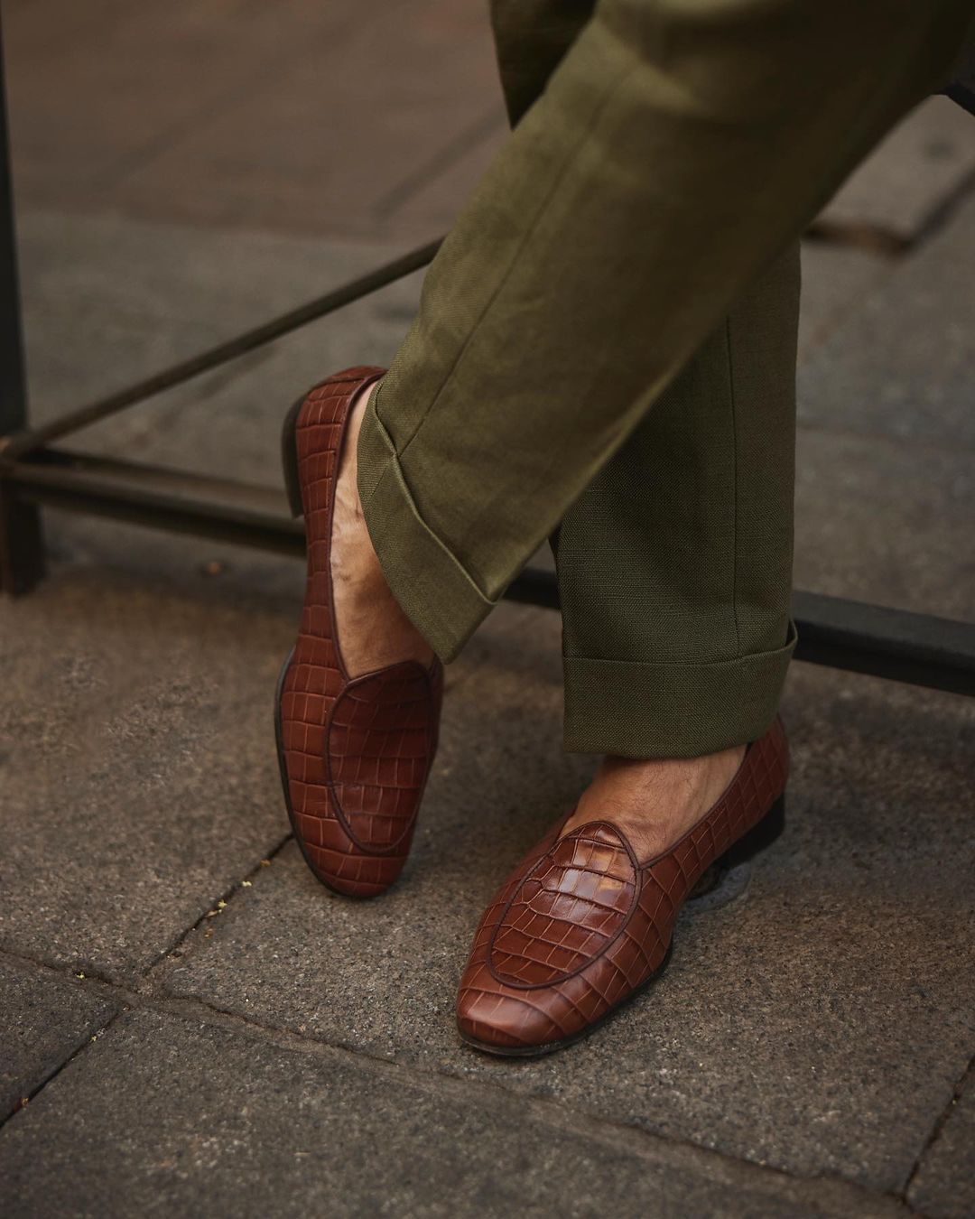 Male model in custom linen Gurkha pants for men by Luxire in olive wearing brown shoes