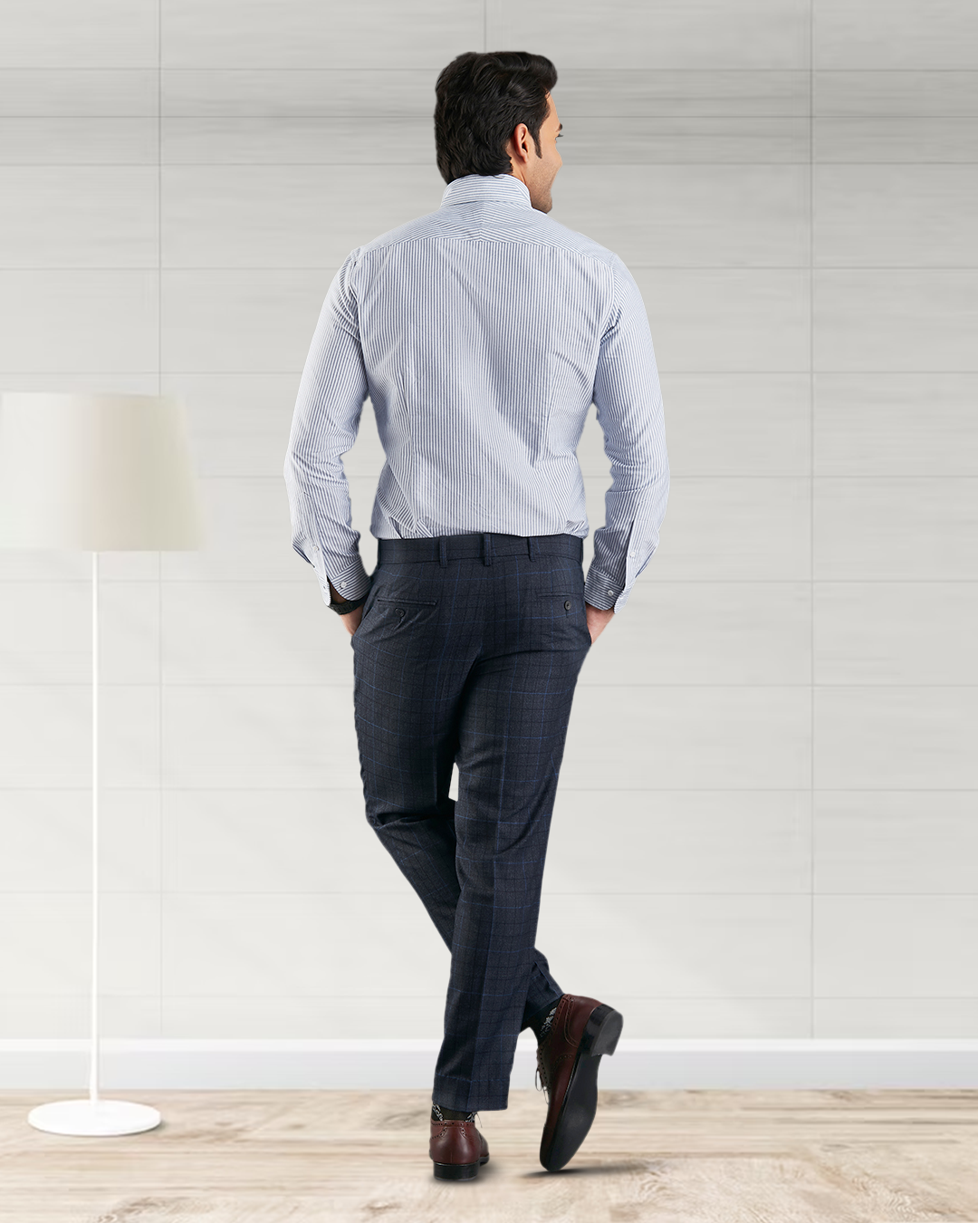 Back of model wearing the custom oxford shirt for men by Luxire with navy university stripes hands in pockets