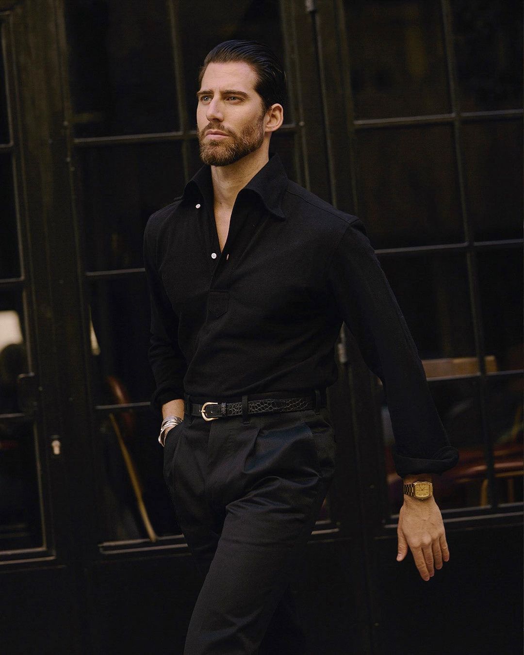 Model wearing the custom oxford polo shirt for men by Luxire in black pique one hand in pocket