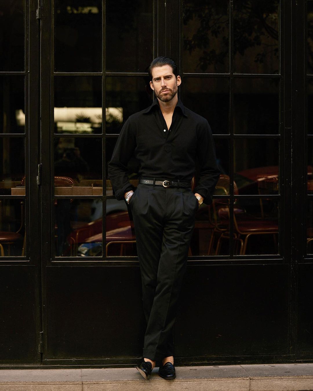 Model wearing the custom oxford polo shirt for men by Luxire in black pique hands in pockets