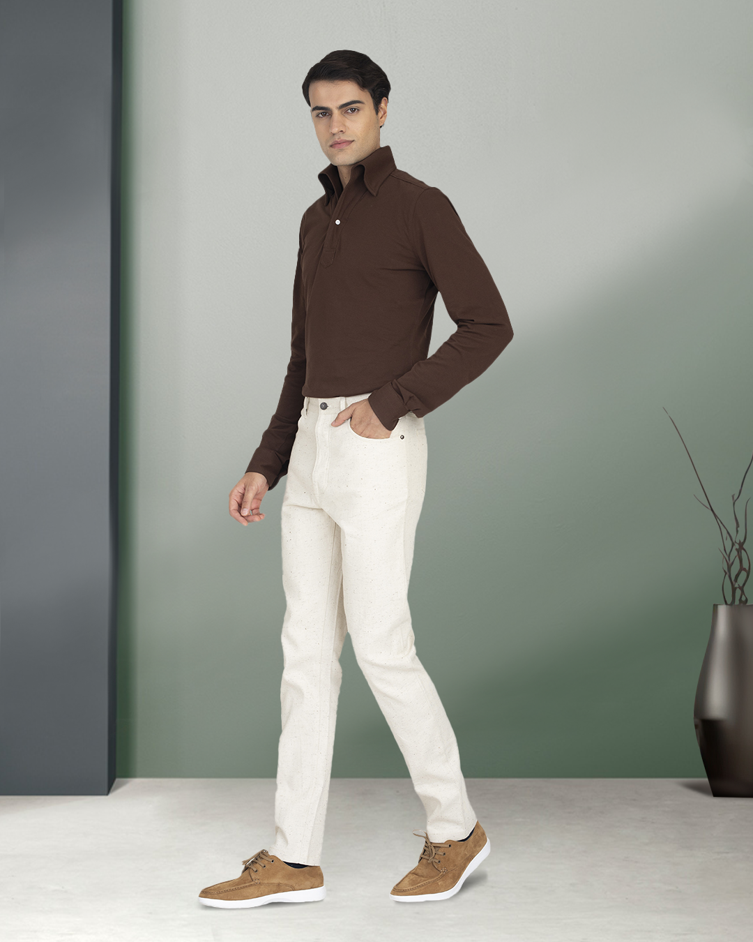 Side of model wearing the custom oxford polo shirt for men by Luxire in brown pique