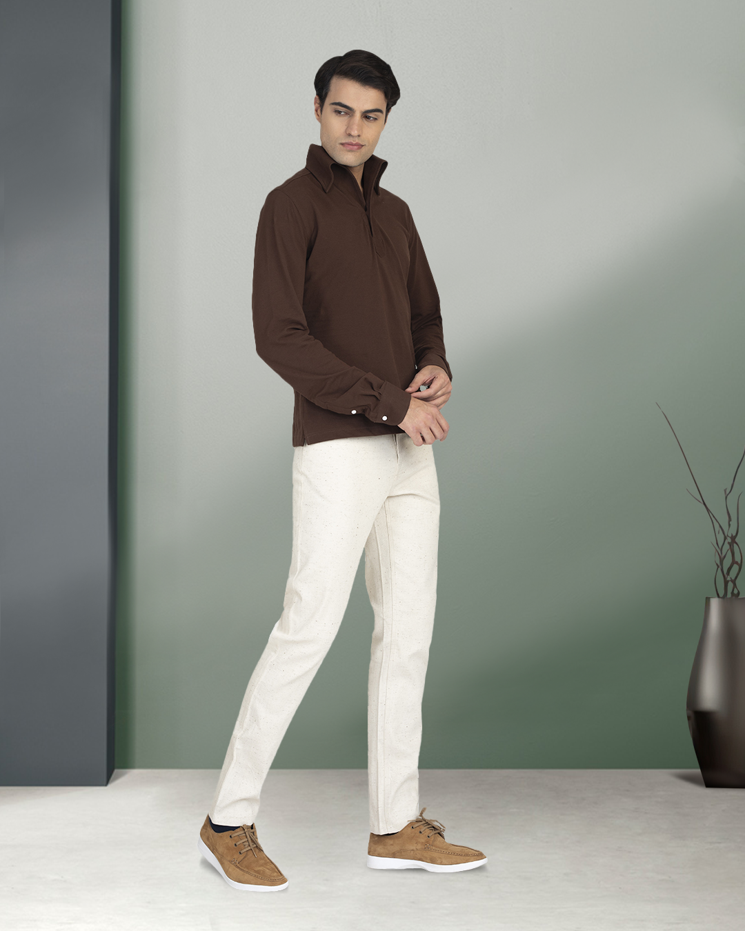 Front of model wearing the custom oxford polo shirt for men by Luxire in brown pique hands at side 3