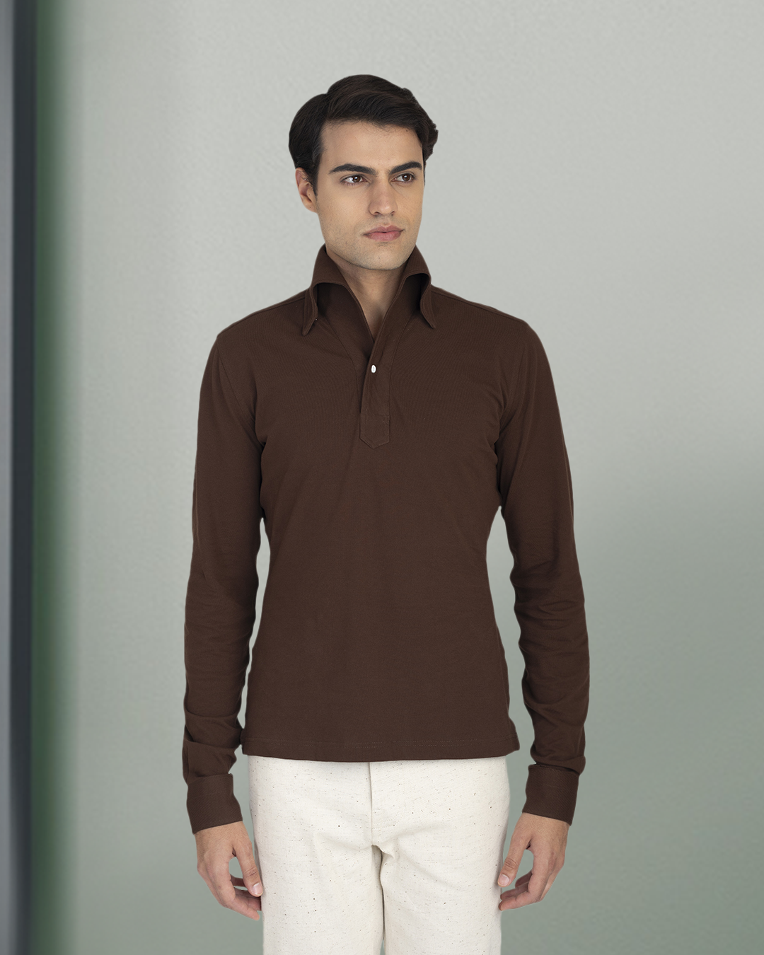 Model wearing the custom oxford polo shirt for men by Luxire in brown pique