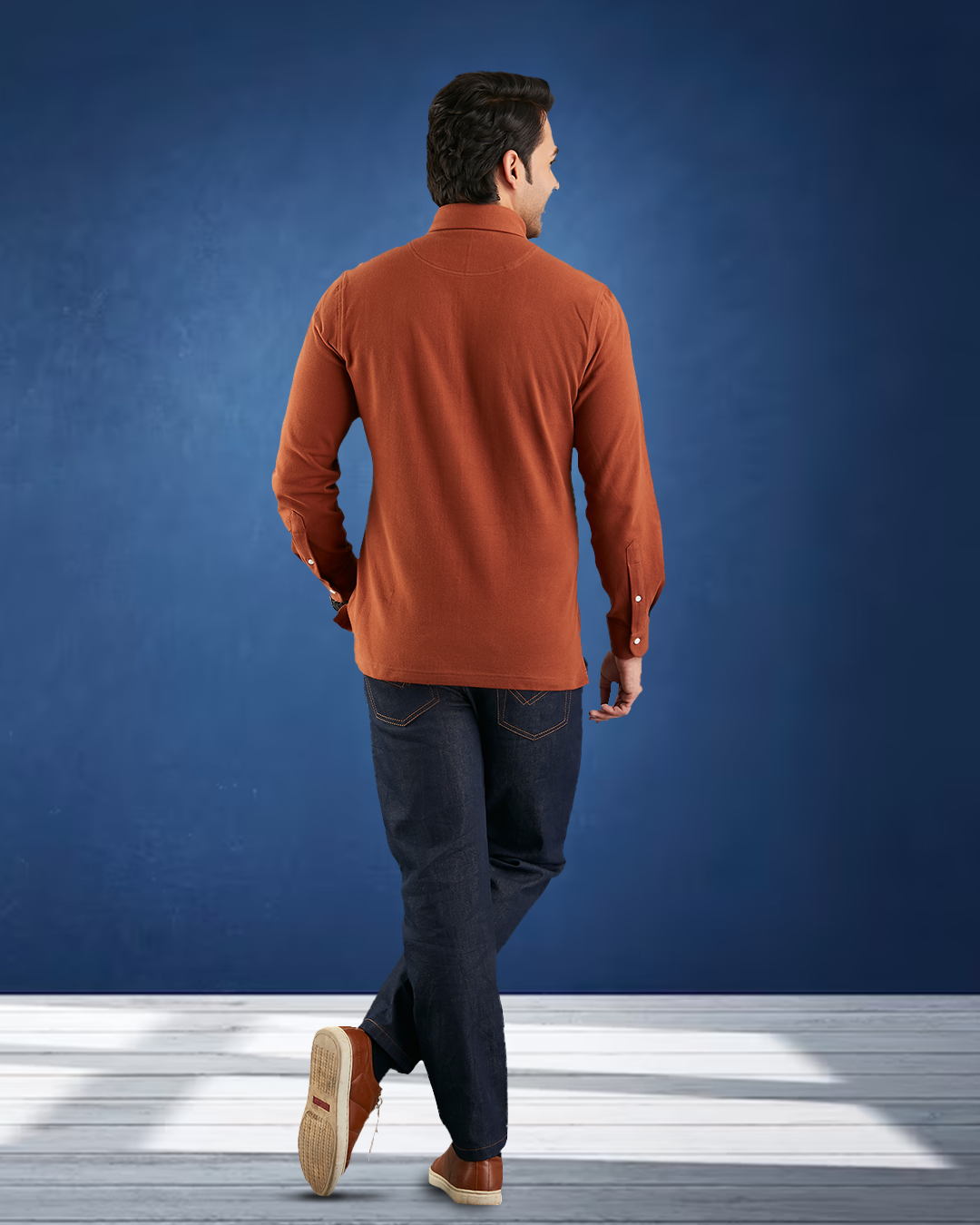 Back of model wearing the custom oxford polo shirt for men by Luxire in copper