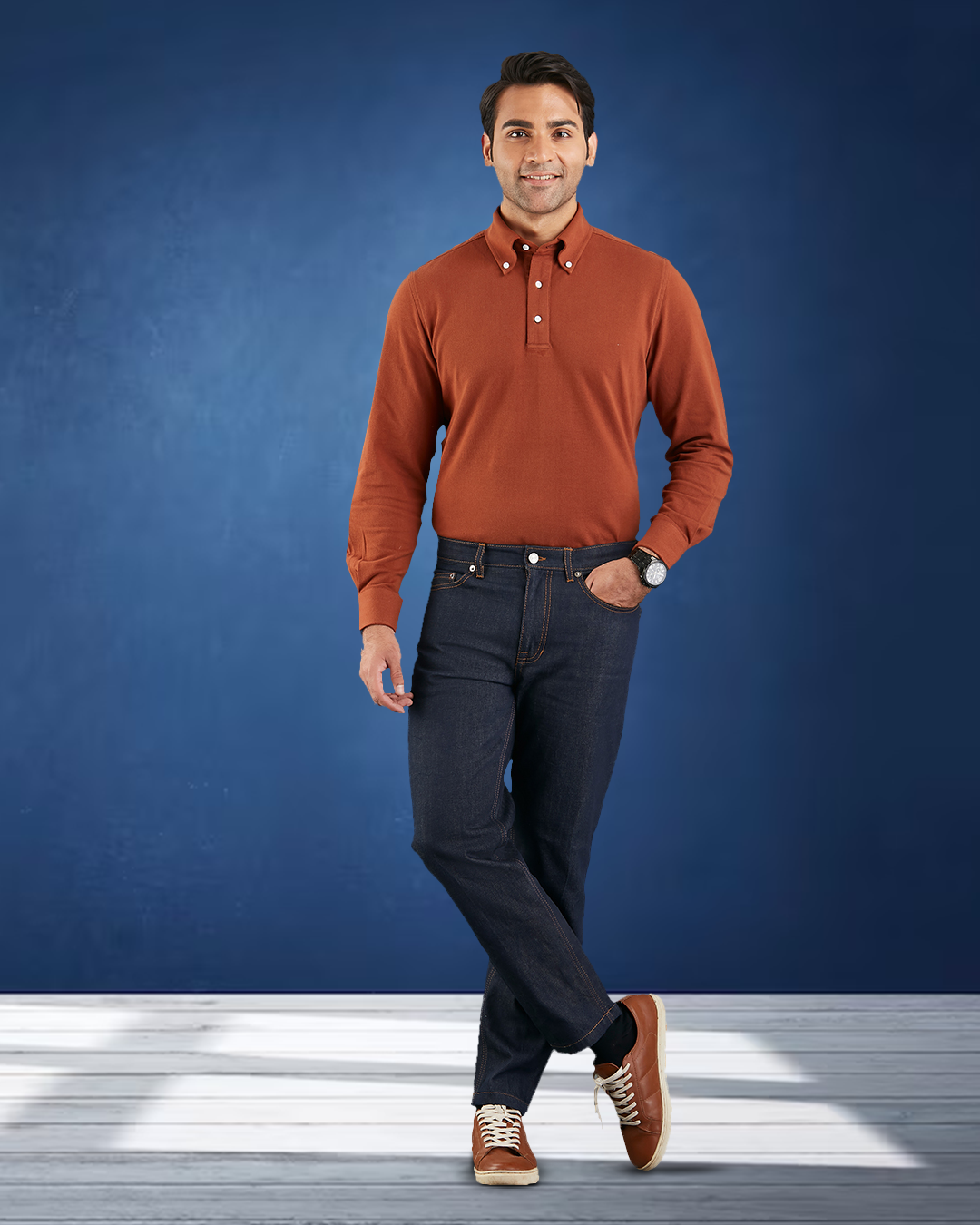 Model wearing the custom oxford polo shirt for men by Luxire in copper one hand in pocket