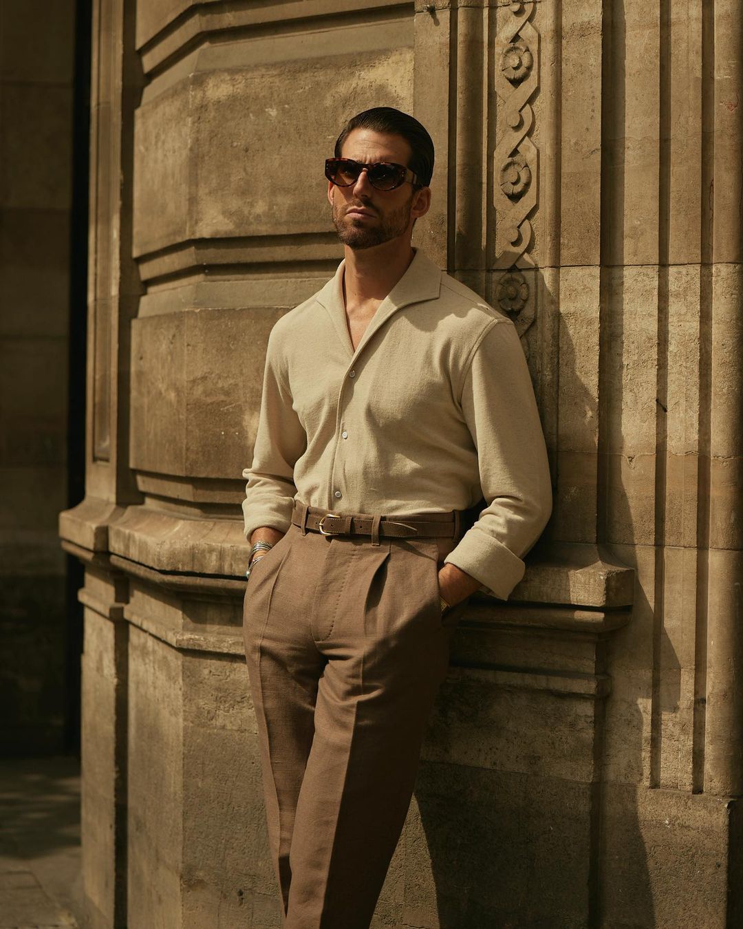 Model wearing the custom oxford polo shirt for men by Luxire in heather cream hands in pockets 2