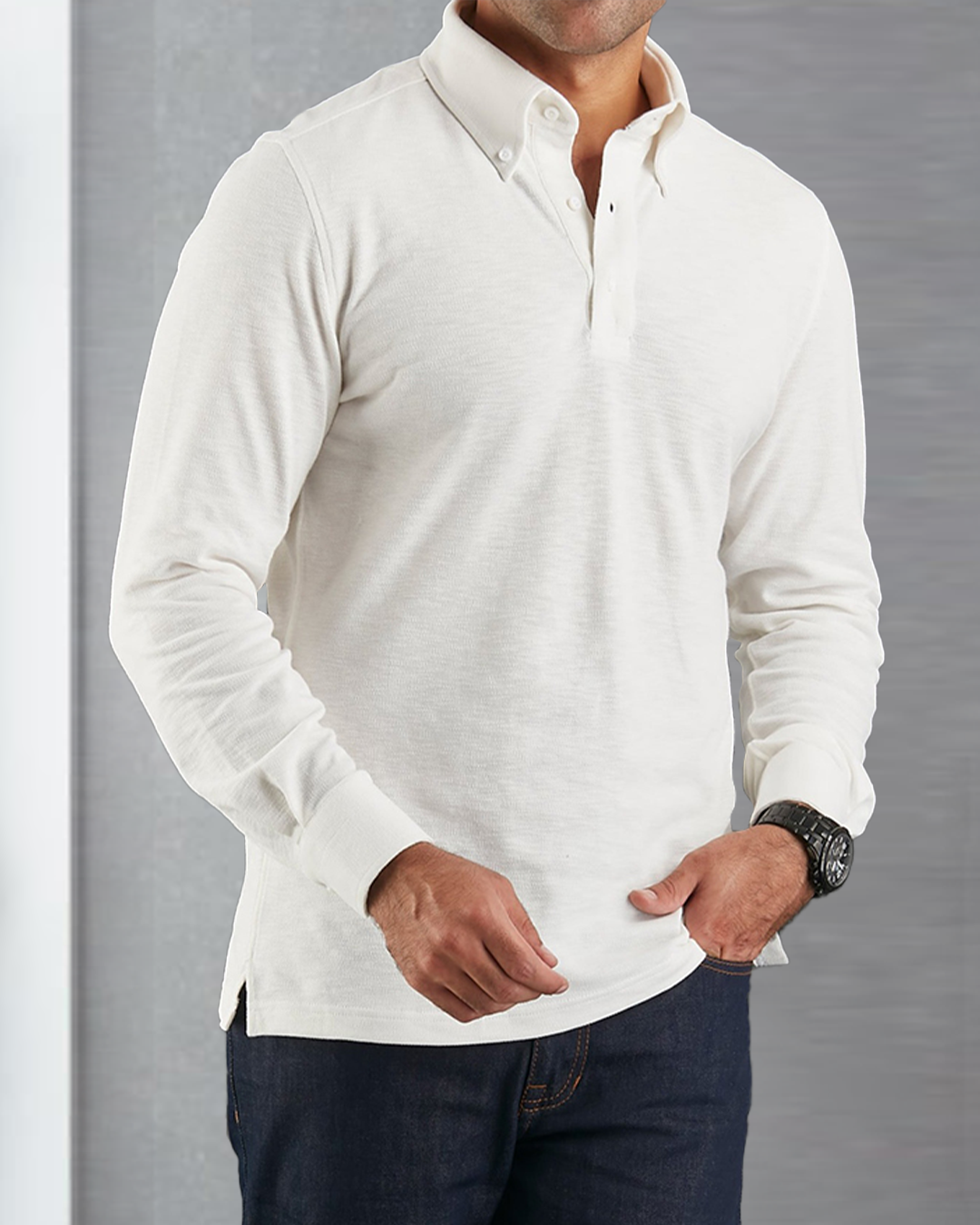 Close up of model wearing the custom oxford polo shirt for men by Luxire in ivory white hands at hips